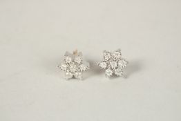 A PAIR OF 9CT GOLD SEVEN STONE DIAMOND DAISY EAR STUDS.