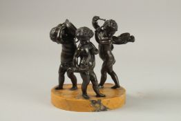 AFTER CLAUDE MICHEL CLODION (19TH CENTURY) THREE BRONZE MUSICANS PUTTI on an oval marble base.