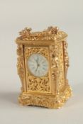 A SMALL GILT CASED CARRIAGE CLOCK. 7cms high.