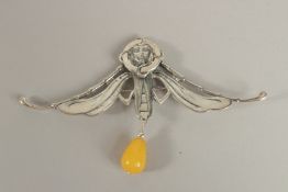 A SILVER NOUVEAU GIRL AND AMBER BROOCH.