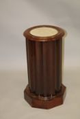 A VICTORIAN MAHOGANY AND MARBLE TOPPED CYLINDRICAL POT CUPBOARD with concave fluted design on an