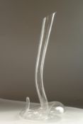 A GLASS CARAFE by RIEDEL, shaped like a snake. 51cms high.