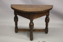 AN 18TH CENTURY OAK CREDENCE TABLE, with demilune fold-over top, on three baluster turned legs,