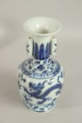 A CHINESE BLUE AND WHITE DRAGON VASE. 28cms high.