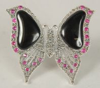 A SILVER ART DECO STYLE ONYX AND RUBY BUTTERFLY BROOCH.
