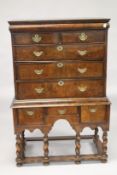 AN 18TH CENTURY WALNUT CHEST ON STAND, with a cushion moulded drawer, two short over two long