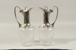 A PAIR OF ART DECO GLASS AND PLATE CLARET JUGS.