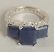 AN 18CT WHITE GOLD THREE-STONE SAPPHIRE RING. Ring Size K+.