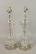 A PAIR OF CUT GLASS LAMPS. 64cms high.
