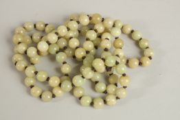 A STRING OF CELADON BEADS. 120cms long.