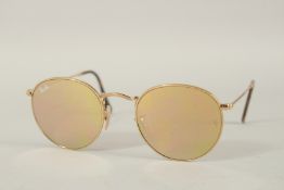 A PAIR OF RAY-BAN SUNGLASSES in a case.