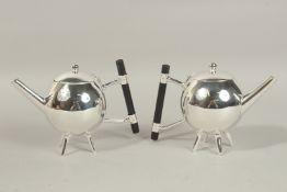 A PAIR OF CHRISTOPHER DRESSER SILVER PLATED GLOBULAR TEAPOTS.