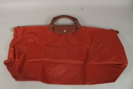 A LONGCHAMP FOLDING BAG.