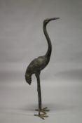 A LARGE LIFE SIZE BRONZE CRANE. 150cms high.