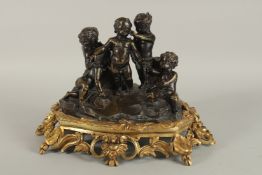 A VERY GOOD BRONZE AND ORMOLU GROUP OF FOUR CUPIDS AT PLAY, the base with shells and acanthus
