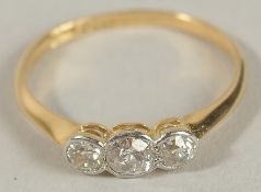 AN 18CT YELLOW GOLD GRADUATED RBC DIAMOND RUBOVER SET TRILOGY RING with stylish box. Diamonds 0.