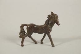A SMALL BRONZE HORSE. 7.5cms high.