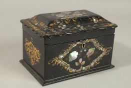A VICTORIAN BLACK PAPIER MACHE TWO-DIVISION TEA CADDY inlaid with mother-of-pearl. 19cms long.