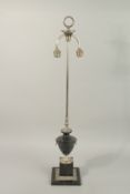 A BLACK MARBLE AND CHROME PLATED URN SHAPED TABLE LAMP, on a stepped square base. 3ft 1ins high.