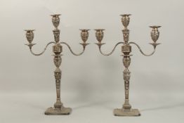A PAIR OF SILVER THREE-LIGHT TWIN-BRANCH CANDELABRA, in Adam Revival style, with urn shaped sconces,