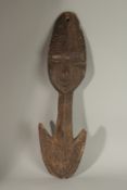 A SEPIK CARVED WOOD RIVER HOOK. 74cms long.
