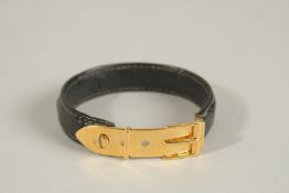 A GUCCI LEATHER AND GILT METAL BRACELET.