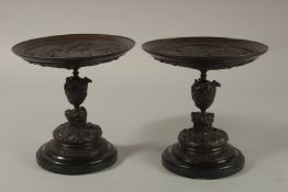 A GOOD PAIR OF 19TH CENTURY BRONZE CLASSICAL TAZZAS, the circular tops with scenes of Rome with