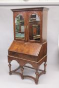 AN 18TH CENTURY WALNUT BUREAU CABINET ON STAND, the upper section with a moulded cornice, pair of