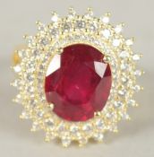 A SILVER GOLD PLATED RUBY CLUSTER RING.