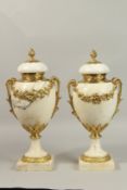 A GOOD PAIR OF LOUIS XVI STYLE WHITE MARBLE URNS AND COVERS with ornate garlands. 42cms high.