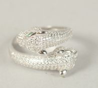 A SILVER DOUBLE PANTHER HEAD CROSSOVER RING. Ring size (P).