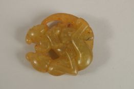 A CARVED EROTIC JADE ROUNDEL. 5cms diameter.