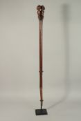 A VERY GOOD WOODEN CLUB, the handle carved as a male and female figure with shaped base, 107cms