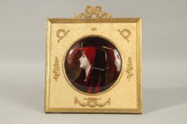 A GOOD 19TH CENTURY FRENCH LIMOGES ENAMEL CIRCULAR HEAD AND SHOULDERS OF A YOUNG GIRL,