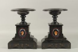 A GOOD PAIR OF ITALIAN BLACK MARBLE TAZZAS with oval masks. 30cms high.