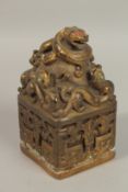 A CHINESE GILT BRONZE SQUARE DRAGON SEAL. 18cms high.