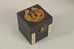 A CHINESE SOAPSTONE LOUHAN FIGURE AND STAND, in a soapstone mounted box.