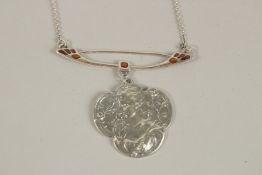 A SILVER NOUVEAU GIRL PENDANT AND CHAIN.
