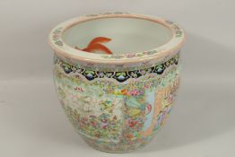 A LARGE CHINESE PORCELAIN CIRCULAR PLANTER, famille rose with panels. 40cms diameter.