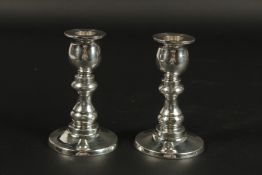 A PAIR OF SQUAT CIRCULAR CANDLESTICKS. 12cms high.