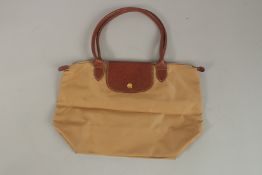 A LONGCHAMP FOLDING BAG.