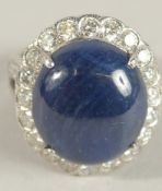 AN 18CT WHITE GOLD CABOCHON SAPPHIRE AND DIAMOND RING. Ring Size L.