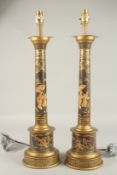 A GOOD PAIR OF TOLEWARE COLUMN LAMPS with Chinese scenes. 50cms high.