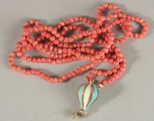 A CORAL NECKLACE AND ENAMEL PENDANT.