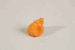 A SMALL PIECE OF CARVED AMBER as a shell. 6.2gms.
