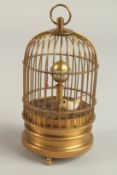 A SMALL GILT METAL BIRD CAGE CLOCK. 13cms high.