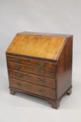 AN 18TH CENTURY WALNUT BUREAU, with a fall flap enclosing a fitted interior with well, above four