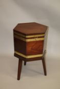 A GOOD GEORGE III MAHOGANY AND BRASS BOUND HEXAGONAL SHAPED CELLERETTE, the hinged top revealing a