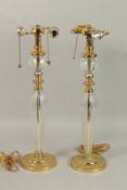 A TALL PAIR OF GLASS AND GILT METAL LAMPS. 60cms high.