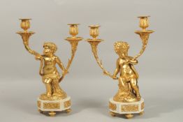 AFTER CLODION A VERY GOOD PAIR OF GILT, BRONZE AND MARBLE TWO-LIGHT CANDELABRA with cupid supports